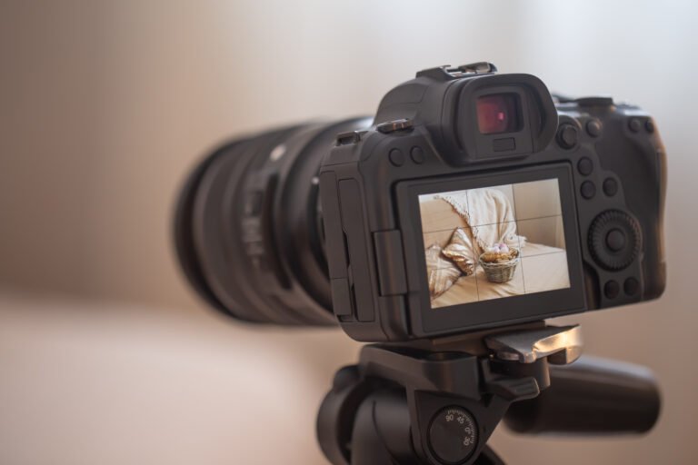 Close up professional digital camera on a tripod on a blurred background. The concept of technology for working with photos and videos.